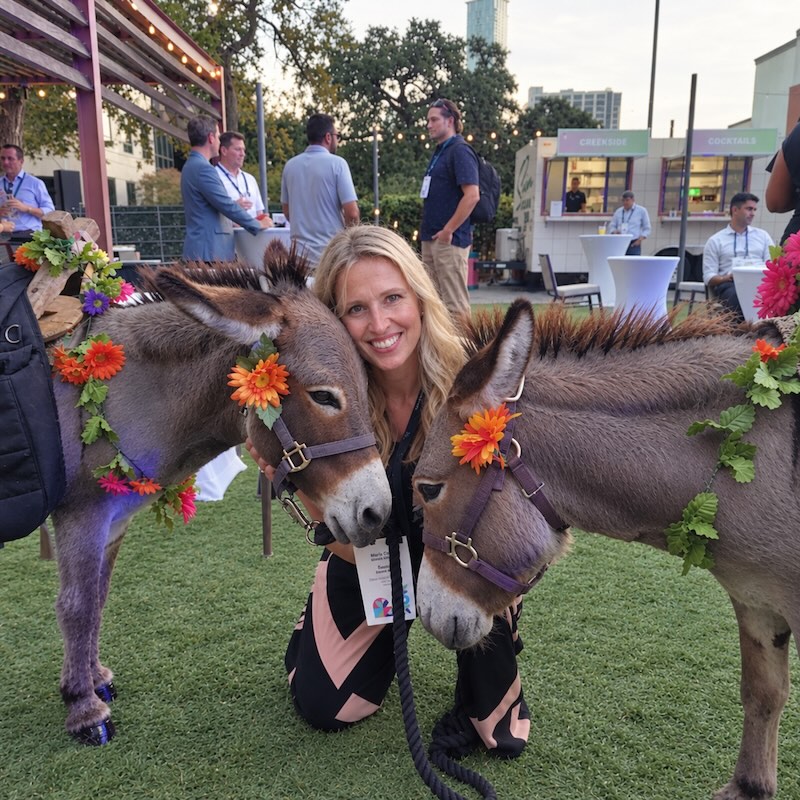 MGH employee at marketing event with two donkeys